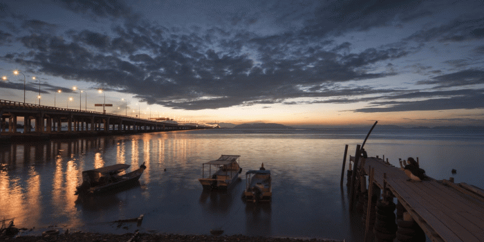 1920x1080 GELUGOR, PENANG/MALAYSIA - 26 FEB 2017: Timelapse of people visit the  coastal side near the penang first bridge with beautiful sunrise which is 