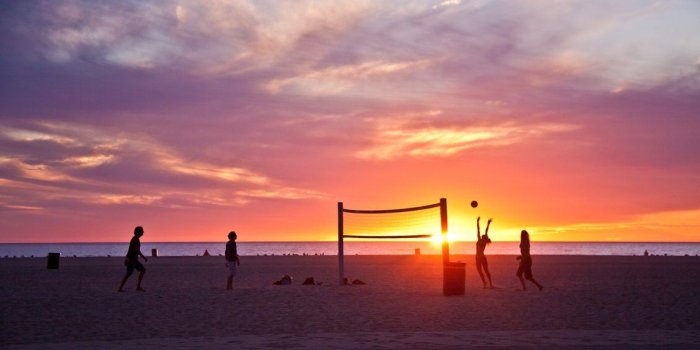1130x706 Volleyball on beach, sunset