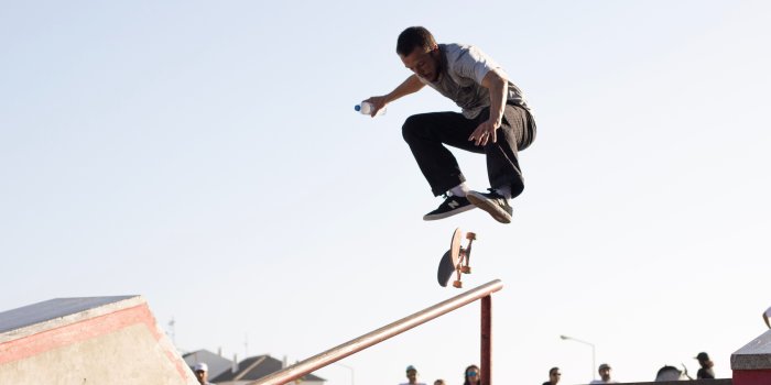 5488x3658 Man Wearing White T-shirt Performing Skateboard Tricks on Rail Under
