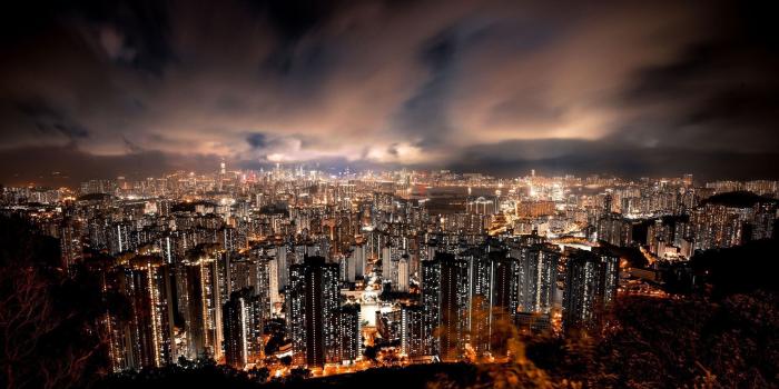 2560x1440 Amazing Hong Kong At Night With Clouds All Over The City Wallpaper