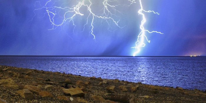 1440x2560 Download wallpaper 1440x2560 lightning, storm, lake, overcast, shore
