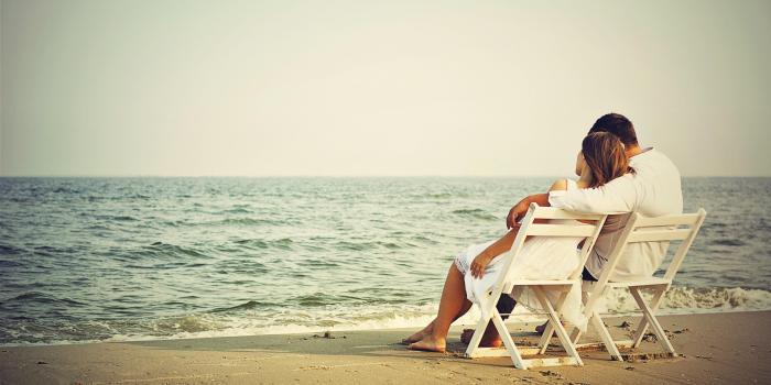 3845x2386 Romantic Couple Seating on Beach Download HD desktop wallpaper