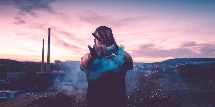 1570x1047 Young Man With Smoke Grenade Free Stock Photo | picjumbo