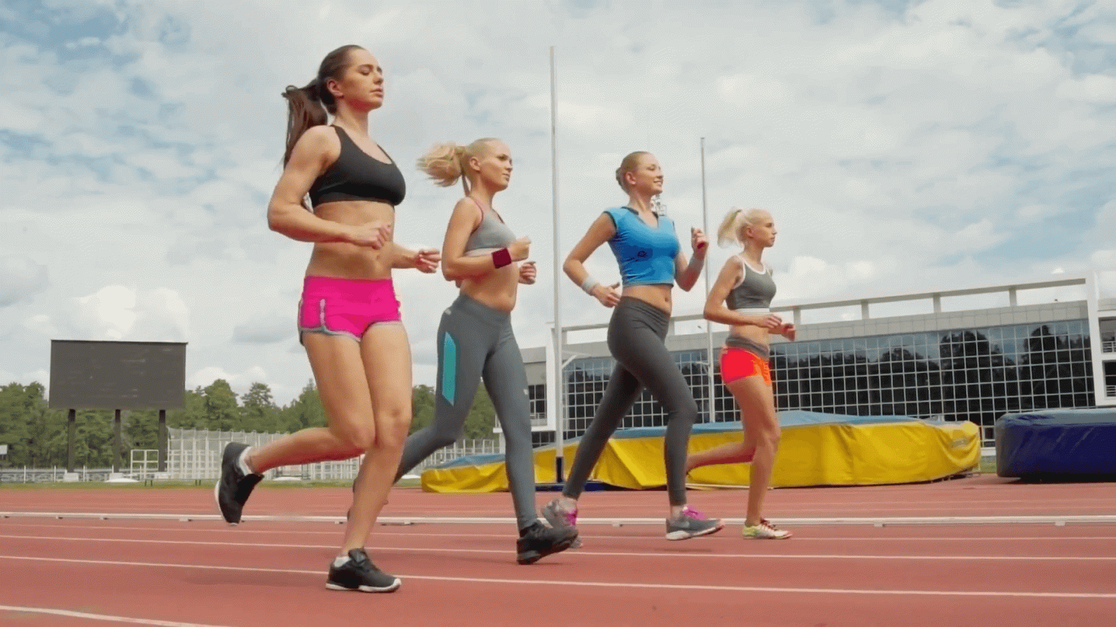 1920x1080 Tracking shot of four beautiful female athletes running on track at stadium  in slow motion Stock Video Footage - Storyblocks Video