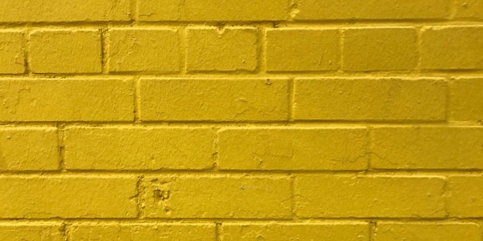 1366x768 Download wallpaper 1366x768 bricks, yellow, wall, texture tablet