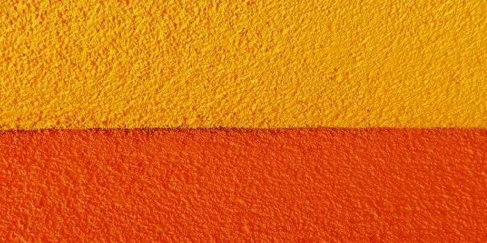 1366x768 Download wallpaper 1366x768 paint, wall, rough, orange, yellow