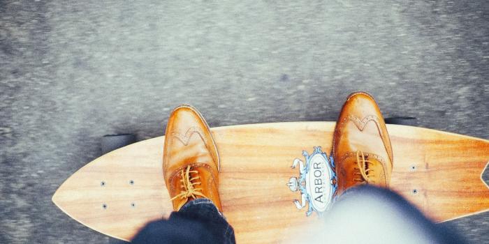 3089x2048 person in brown oxford wingtip leather shoes riding on brown penny