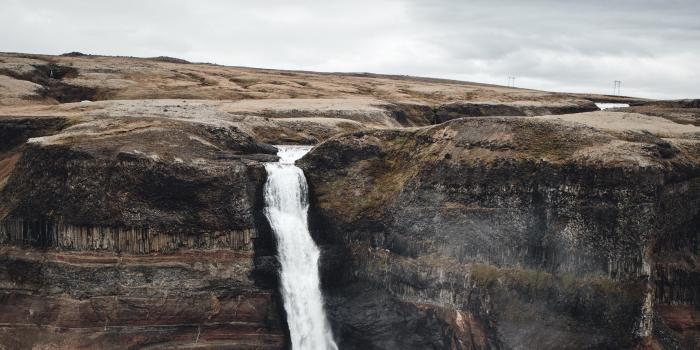 2560x1440 Download wallpaper 2560x1440 waterfall, cliff, stone, landscape