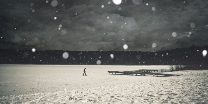 1920x1080 Photo of Man Walking on a Frozen Lake in the Snow - Black & White