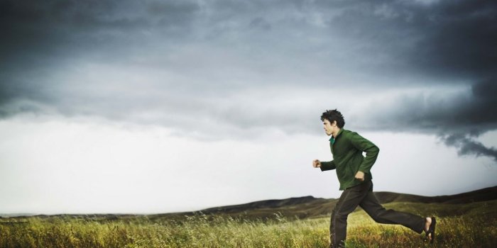 1366x768 Download wallpaper 1366x768 field, sports, running, storm, clouds