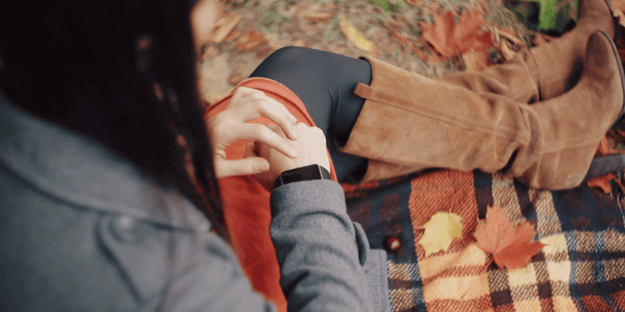 1920x1080 Beautiful, stylish, young womam uses smart clock sitting on plaid in autumn  park. 4k