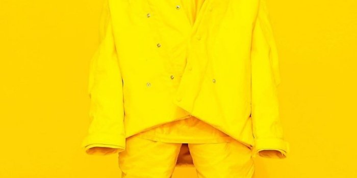 950x1689 Download Billie Eilish Yellow Background Free Pure 4K Ultra HD