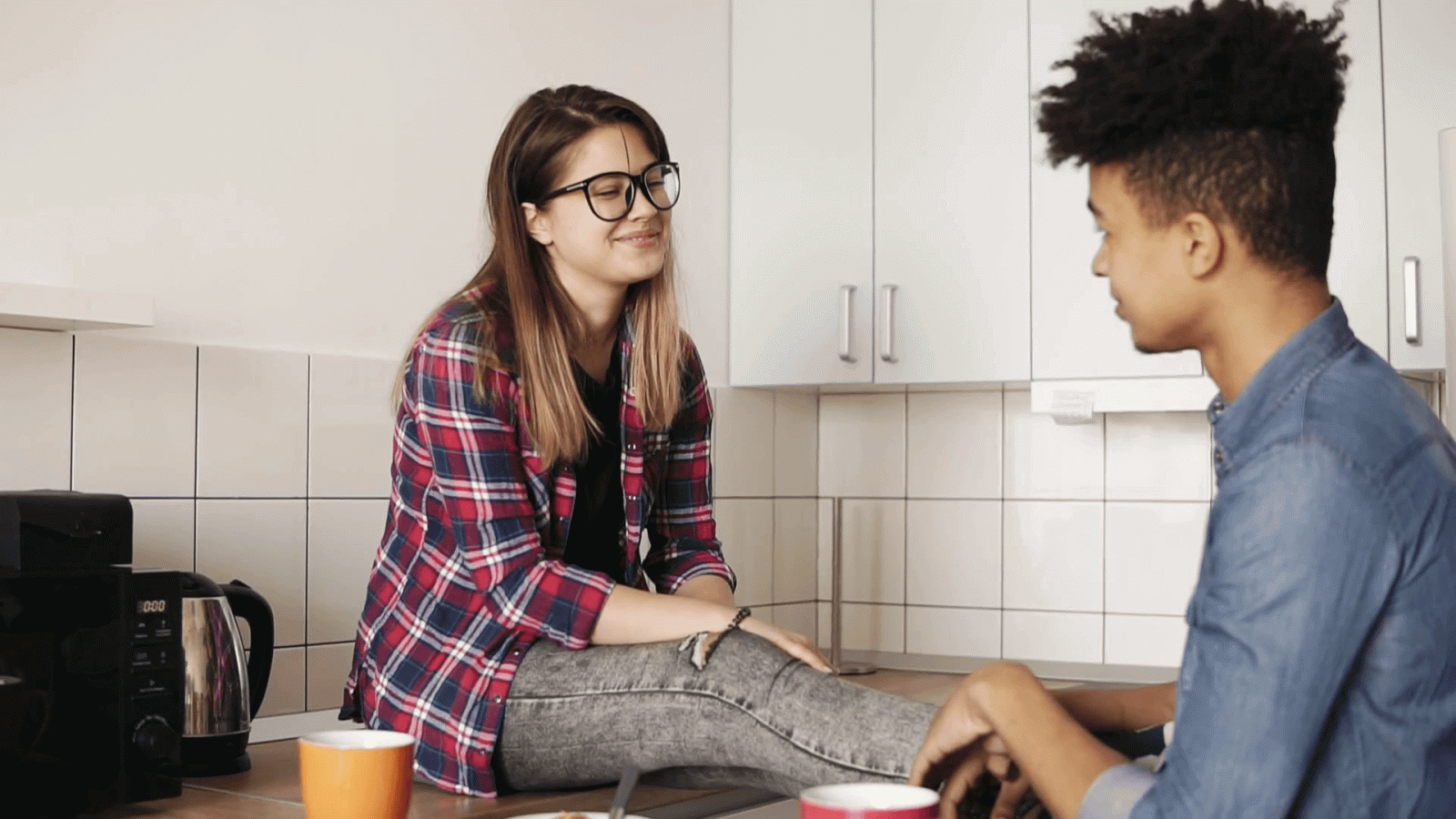 1920x1080 Cute couple of two young people in love having a descent conversation,  sitting in a comfy kitchen, enjoying their meal, smiling and laughing.