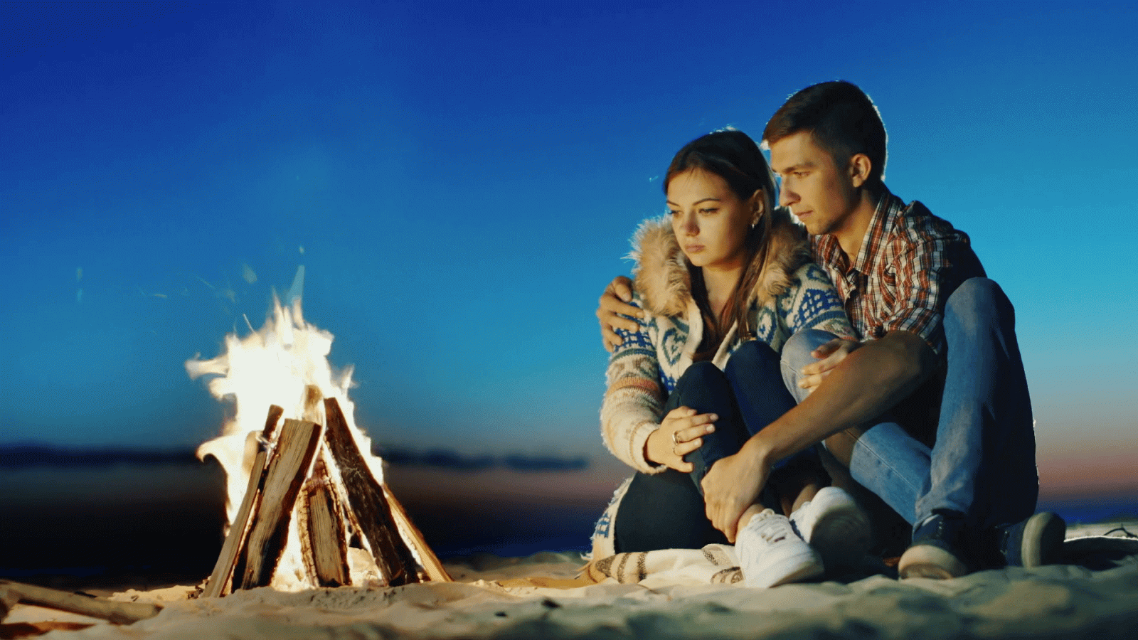 1920x1080 Romantic young couple sitting on the beach campfire. Hug, admiring the  fire, dreaming Stock Video Footage - Storyblocks Video