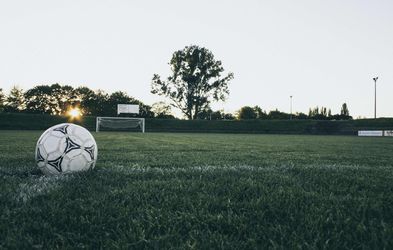2972x1896 2389458 old soccer ball laying on the grass field waiting to be