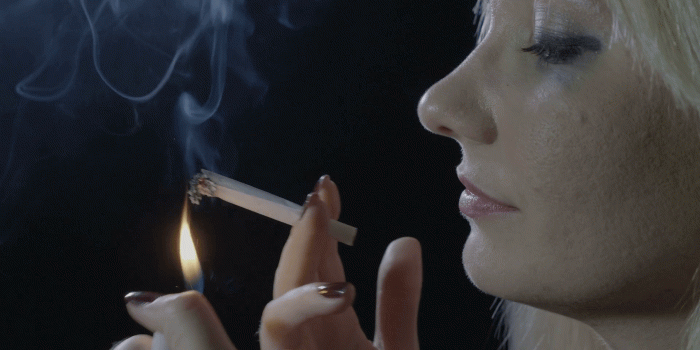 1920x1080 Drug addicted blonde woman with blue eyes lightning a marijuana joint  smoking it and relaxing Stock Video Footage - Storyblocks Video