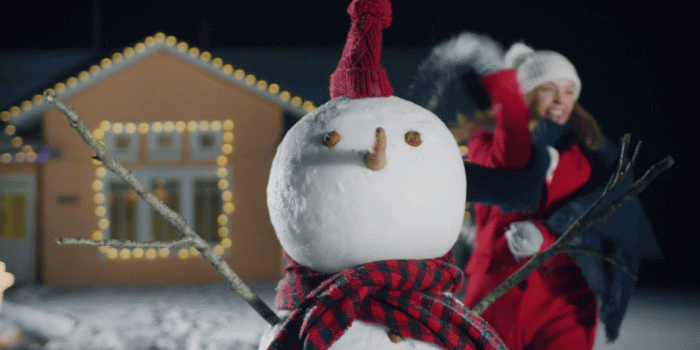 1920x1080 Cute Snowman Standing in the Backyard of the House. In the Background  Couple in Love Playing in Snowballs. Winter Evening Fun. Stock Video  Footage -