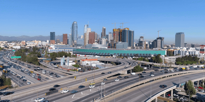 1920x1080 Cinematic urban aerial view of downtown Los Angeles, freeway, interstate  and L.A. convention center as seen from the interstate.