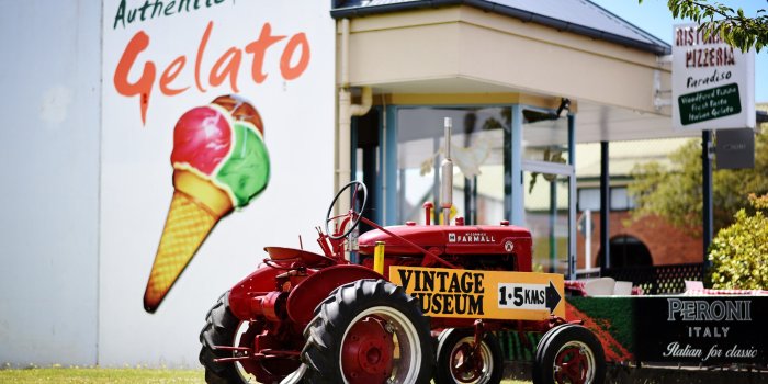 3134x2089 a vintage tractor sitting outside of a gelato shop in new