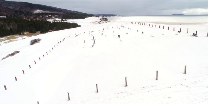 1920x1080 Aerial Shot Of A Small Cemetery In A Snowy Field By The Ocean