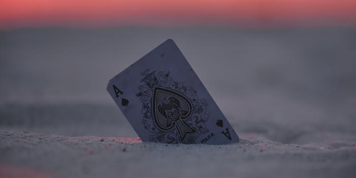 2560x1440 Download wallpaper 2560x1440 card, ace, sand, sunset, closeup