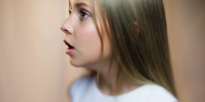 1920x1080 Nervous face young blonde girl makes an angry face talk speak
