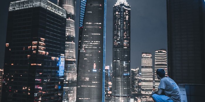 910x1365 HD wallpaper: man sitting on roof top viewing city view, building