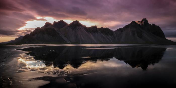 3840x2560 smooth eroded mountains reflected in a half frozen lake in