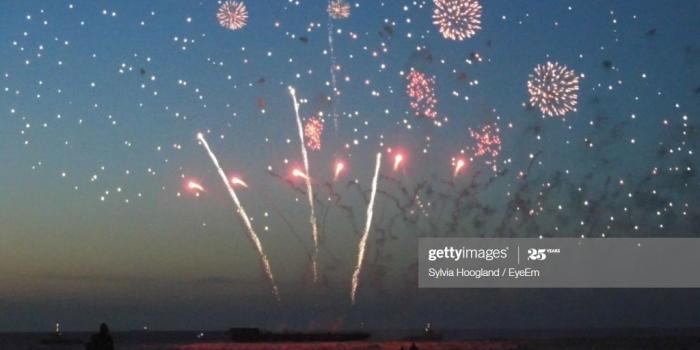 1024x768 Fireworks Exploding Against Blue Sky At Beach During Sunset High