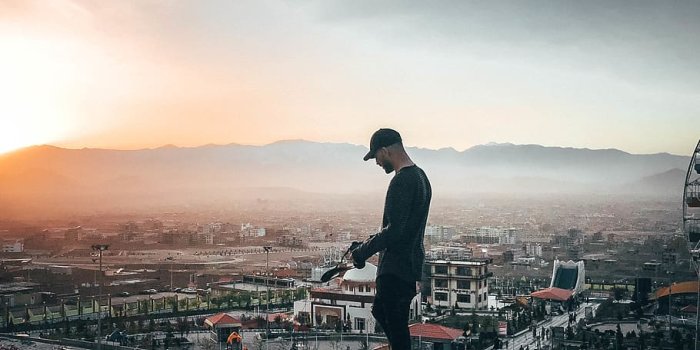 910x867 HD wallpaper: Man Standing Outdoors, cap, evening sun, golden hour