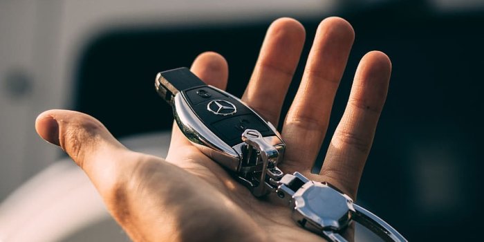 910x1365 HD wallpaper: person holding Mercedes-Benz fob, hand, key, car