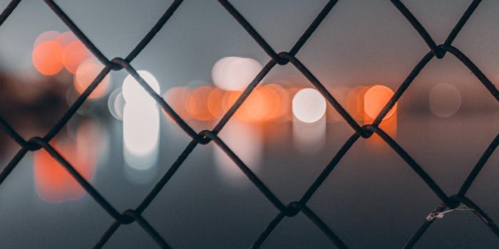 1242x2688 chain link fence behind bokeh iPhone X Wallpapers Free Download