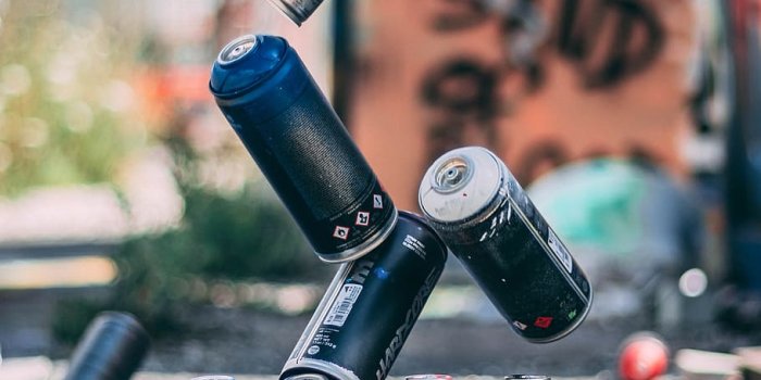 910x1617 HD wallpaper: selective focus photo of flying spray paint cans o