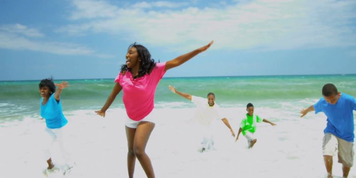 1245x700 African american family spending summer holiday together on beach