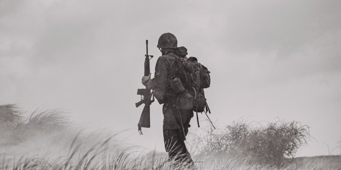 1000x1148 grayscale photo of man in black jacket and pants holding rifle photo – Free  Grey Image on Unsplash