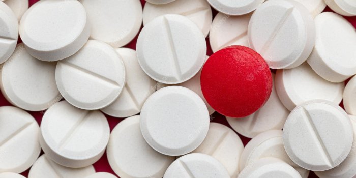 2000x1333 Premium Photo | White round tablets and one red pharmacy medications wallpaper  backgrounds and texture