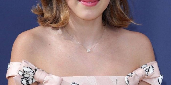 831x1200 Download Millie Bobby Brown radiates grace in a pink floral dress. Wallpaper  | Wallpapers.com