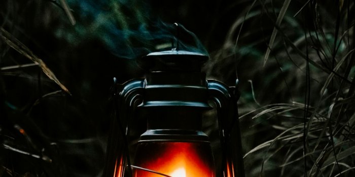 1000x1250 A lit lantern sitting in the middle of