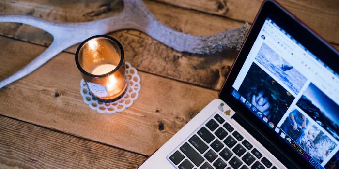 3840x2560 a lit candle and an antler on a table next to a laptopcandle antler