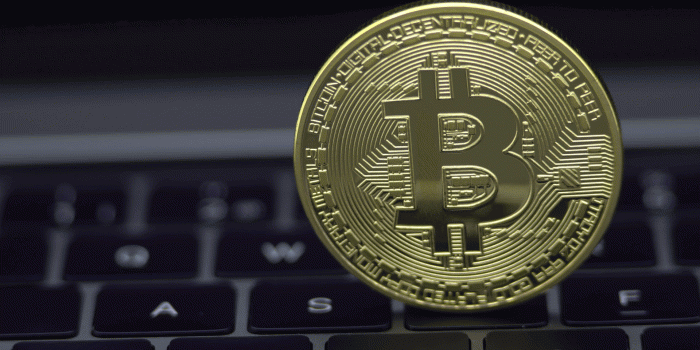 1920x1080 4K Physical metal golden Bitcoin currency on notebook computer keyboard.  Worldwide virtual internet money. Digital coin cyberspace, cryptocurrency 