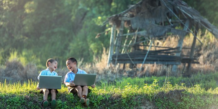 5000x3168 Two boy using laptops in front of a brown nipa hut HD wallpaper