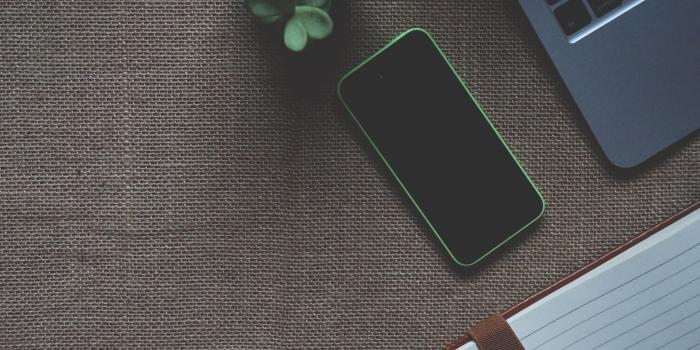 2506x1873 Person taking photo of green iPhone 5c near grey laptop HD wallpaper