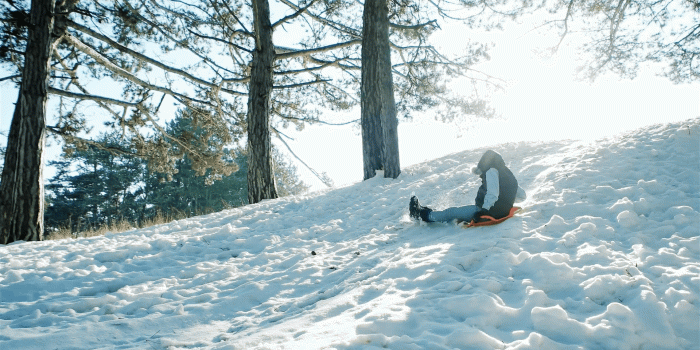 1920x1080 Boy sledding down the hills, sleigh ride through the snow, fun winter  entertainments, happy child moves down on a sled backlit in sunlight, fast 