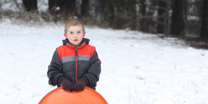 3840x2560 3010741 boy, sledding, snow, snow sled 4k wallpaper and background
