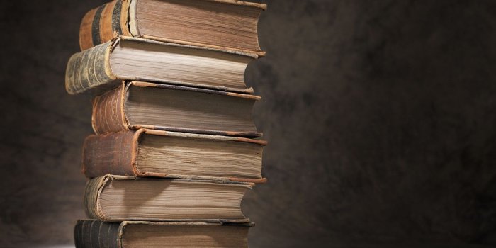 1332x850 Wallpaper macro, table, books, blur, stack, books, vintage, bokeh